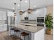 Bright kitchen with large island, granite countertops, white cabinets, and stainless steel appliances at 199 Verde Way, Debary, FL 32713