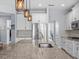 Kitchen island with granite countertop, stainless steel sink, and stylish pendant lighting at 199 Verde Way, Debary, FL 32713