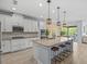 Bright kitchen featuring granite countertops, white cabinets, stainless steel appliances, and a large island at 199 Verde Way, Debary, FL 32713