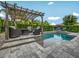 Inviting backyard pool area featuring a pergola with seating and lush landscaping for added privacy at 199 Verde Way, Debary, FL 32713