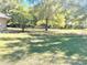 Expansive backyard with lush green grass and mature trees creating a serene outdoor space at 2053 Bond Rd, Deland, FL 32720