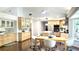 Bright, open kitchen with light wood cabinetry, stainless appliances, island seating, and hardwood floors at 2053 Bond Rd, Deland, FL 32720