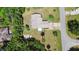 Aerial view of a home with a large backyard and a long driveway, surrounded by trees at 219 Brevity Ln, Deland, FL 32724