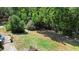 Spacious backyard featuring green grass, lush trees, and a shady area along the fence line at 219 Brevity Ln, Deland, FL 32724
