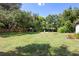 Large backyard with mature trees provides a private outdoor retreat for relaxation and enjoyment at 219 Brevity Ln, Deland, FL 32724