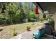 Large backyard featuring green grass, mature trees, and a patio area for outdoor dining and relaxation at 219 Brevity Ln, Deland, FL 32724