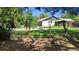 Expansive backyard featuring mature trees and a charming swing set at 219 Brevity Ln, Deland, FL 32724