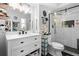 Modern bathroom featuring shower with glass door, vanity, and decorative shelves at 219 Brevity Ln, Deland, FL 32724