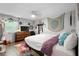 Comfortable bedroom with a ceiling fan, wood floors, an area rug, and natural lighting at 219 Brevity Ln, Deland, FL 32724