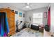 Bedroom featuring wood floors, a patterned rug and a ceiling fan at 219 Brevity Ln, Deland, FL 32724