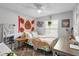 Bright bedroom features a ceiling fan, a side table and a work space at 219 Brevity Ln, Deland, FL 32724