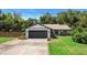 Charming one-story home with a well-manicured lawn and attached two-car garage at 219 Brevity Ln, Deland, FL 32724