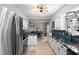 Charming kitchen with marble countertops, white cabinets, blue backsplash, and stainless steel appliances at 219 Brevity Ln, Deland, FL 32724