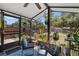 Enclosed sunroom with comfortable seating, potted plants, and views of the backyard at 219 Brevity Ln, Deland, FL 32724