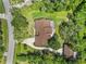 An aerial view of the property showcasing the roof, surrounding trees and lawn at 229 Riverbend Rd, Ormond Beach, FL 32174