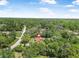 Aerial view of a charming home surrounded by verdant landscaping, offering a sense of tranquility and seclusion at 229 Riverbend Rd, Ormond Beach, FL 32174