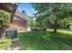 View of brick chimney and an outside patio seating area, nestled into a naturally shaded backyard at 229 Riverbend Rd, Ormond Beach, FL 32174