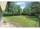 Large, grassy backyard with room to roam and tall trees for privacy at 229 Riverbend Rd, Ormond Beach, FL 32174