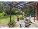 Backyard featuring stone landscape and seating, with fenced yard in background at 229 Riverbend Rd, Ormond Beach, FL 32174