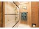 Bathroom showcasing tiled shower and bathtub with glass doors and decorative wall art at 229 Riverbend Rd, Ormond Beach, FL 32174