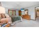 Cozy bedroom featuring a ceiling fan, access to lanai, and ample storage with a large dresser at 229 Riverbend Rd, Ormond Beach, FL 32174