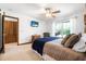 Bedroom featuring a ceiling fan, television, and large window with natural lighting at 229 Riverbend Rd, Ormond Beach, FL 32174