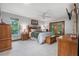 Spacious bedroom offers plenty of natural light, ceiling fan, wood furniture and access to screened lanai at 229 Riverbend Rd, Ormond Beach, FL 32174