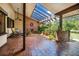 Enclosed courtyard with brick flooring, a ceiling fan, skylights, and a decorative brick wall, creating a cozy outdoor living space at 229 Riverbend Rd, Ormond Beach, FL 32174