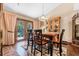Elegant dining room with wood floors, a chandelier, and doors to the outside offering a perfect space for entertaining at 229 Riverbend Rd, Ormond Beach, FL 32174