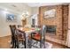 Bright dining room featuring a wooden table, brick fireplace, and chandelier providing a cozy atmosphere for Gathering meals at 229 Riverbend Rd, Ormond Beach, FL 32174