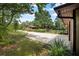 Long driveway leading up to a home with lush landscaping providing a beautiful entrance at 229 Riverbend Rd, Ormond Beach, FL 32174