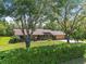 Charming single-story brick home with mature trees and lush landscaping at 229 Riverbend Rd, Ormond Beach, FL 32174