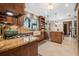 Spacious kitchen featuring custom cabinets, granite countertops, tile backsplash, and modern appliances at 229 Riverbend Rd, Ormond Beach, FL 32174