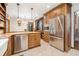 Spacious kitchen boasting stainless steel appliances and custom wood cabinets at 229 Riverbend Rd, Ormond Beach, FL 32174