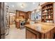 Bright kitchen features custom wood cabinets, granite countertops, stainless steel appliances, and large farmhouse sink at 229 Riverbend Rd, Ormond Beach, FL 32174
