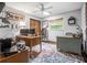 Home office featuring a colorful patterned rug, a large window, and multiple desks at 229 Riverbend Rd, Ormond Beach, FL 32174