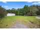 Exterior shot of property featuring a barn with a well-maintained lawn, chicken coop, and fencing at 2395 Old Reynolds Rd, De Leon Springs, FL 32130