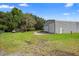 Exterior shot of property featuring a barn and a well-maintained lawn at 2395 Old Reynolds Rd, De Leon Springs, FL 32130