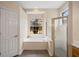 Bathroom featuring a garden tub, glass shower and a bright window at 2395 Old Reynolds Rd, De Leon Springs, FL 32130