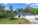 Charming single-Gathering home with solar panels, a well-manicured lawn, and a two-car garage at 2395 Old Reynolds Rd, De Leon Springs, FL 32130