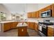 Bright kitchen featuring oak cabinets, stainless steel appliances, and ample counter space at 2395 Old Reynolds Rd, De Leon Springs, FL 32130