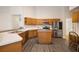 Well-equipped kitchen with oak cabinets, stainless steel appliances, and a functional center island at 2395 Old Reynolds Rd, De Leon Springs, FL 32130