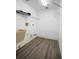 Functional laundry room with laminate flooring and shelving for convenient storage solutions at 2395 Old Reynolds Rd, De Leon Springs, FL 32130