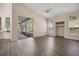 Open living room with wood flooring, high ceilings, and a sliding glass door to the lanai at 2395 Old Reynolds Rd, De Leon Springs, FL 32130