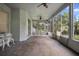 Expansive screened patio offers outdoor seating, ceiling fans, and views of the lush backyard at 2395 Old Reynolds Rd, De Leon Springs, FL 32130