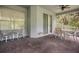 Large screened lanai with ceiling fans and seating provides a relaxing outdoor living space at 2395 Old Reynolds Rd, De Leon Springs, FL 32130