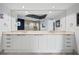 Bathroom with a double sink vanity, large mirror, and walk-in shower at 241 Riverside Dr # 1909, Daytona Beach, FL 32117