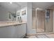 Bright bathroom featuring a dual-sink vanity and a glass-enclosed shower at 241 Riverside Dr # 1909, Daytona Beach, FL 32117