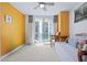 Bright bedroom features a balcony, ceiling fan and comfortable daybed for relaxing and enjoying the view at 241 Riverside Dr # 1909, Daytona Beach, FL 32117