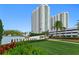 The Marina Grande community is marked by its impressive sign, lush landscaping, and modern architecture at 241 Riverside Dr # 1909, Daytona Beach, FL 32117